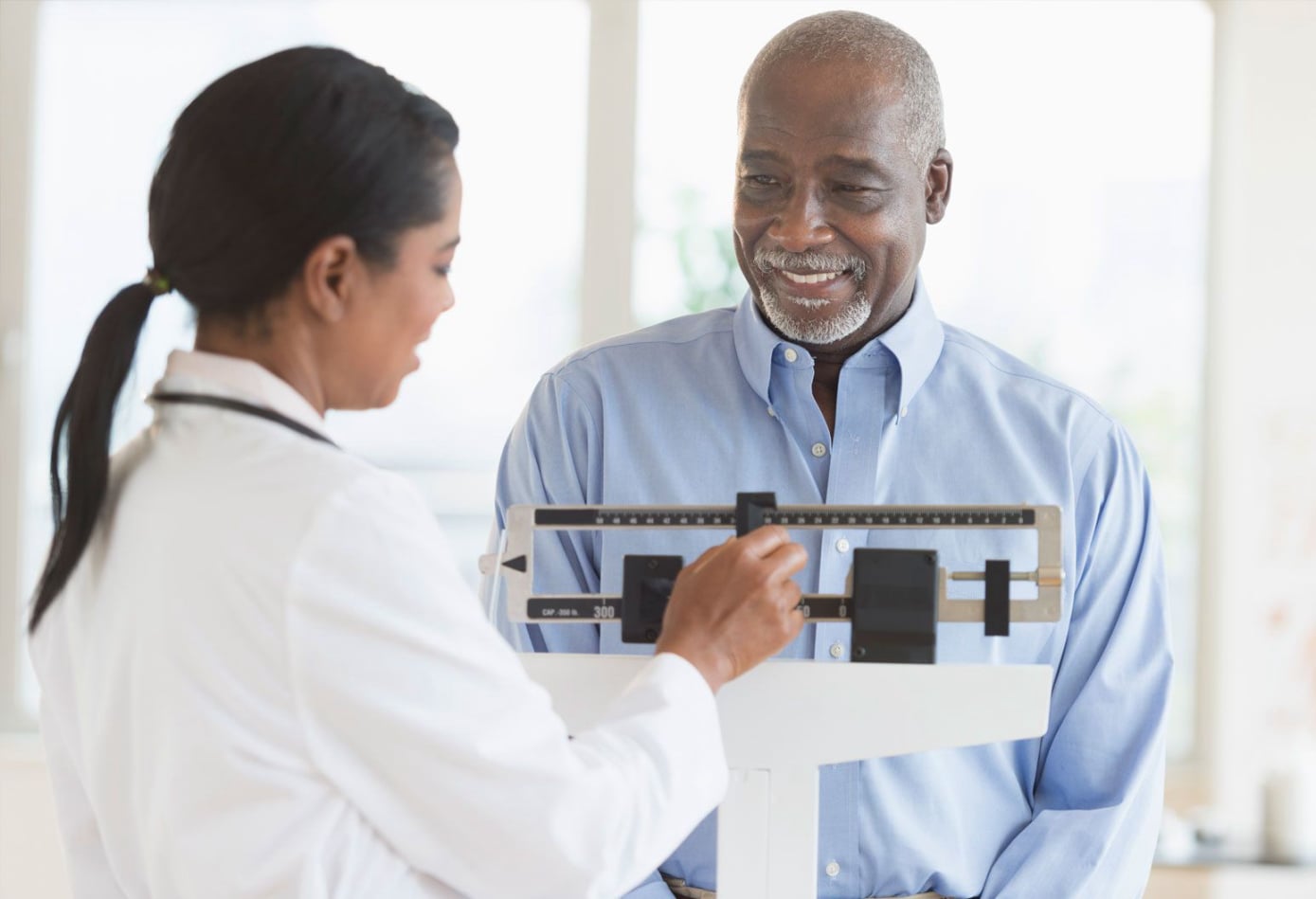 Doctor checking blood pressure and discussing treatment plan with patient at PremierMD